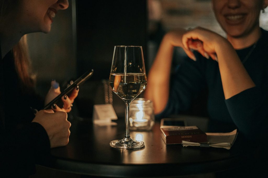 a group of people sitting at a table with a cell phone